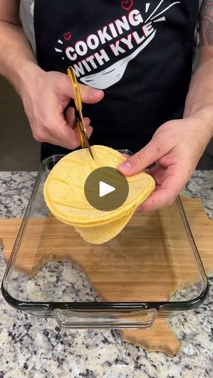 a person in an apron preparing food on a cutting board