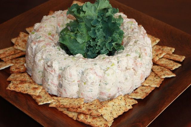 a platter with crackers and vegetables on it