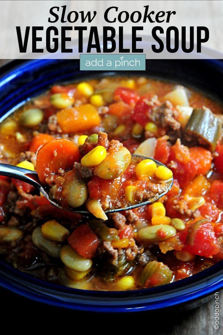 slow cooker vegetable soup in a blue bowl with a spoon