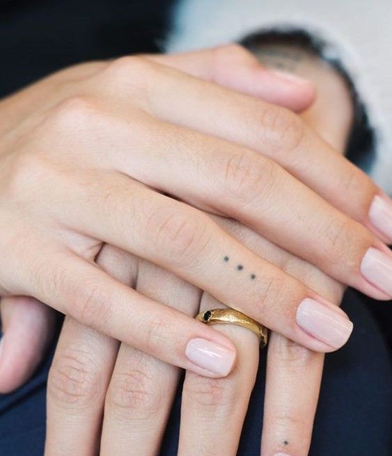 two people with wedding rings on their fingers