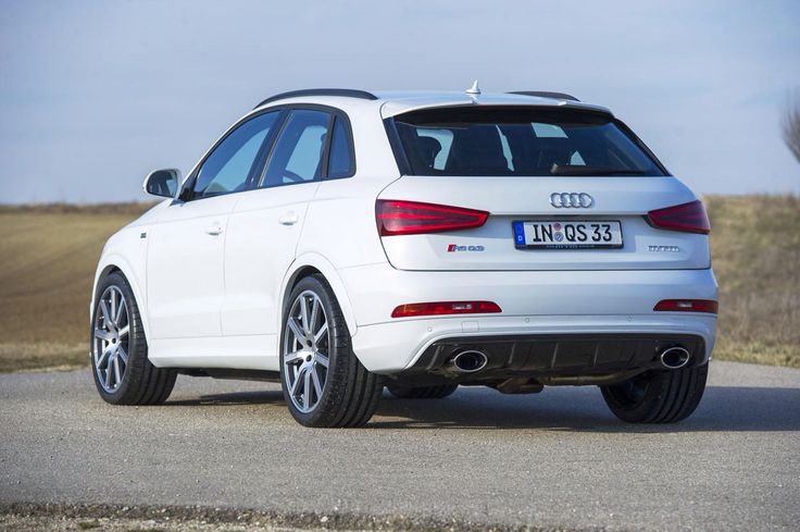 the rear end of a white car on a road