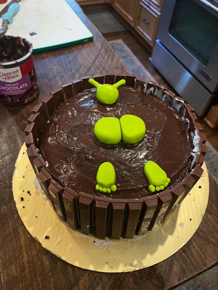 a chocolate cake with green decorations on top