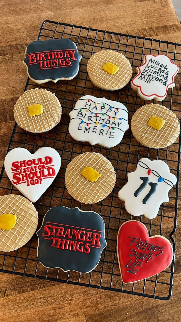 some cookies are on a cooling rack and have been decorated with different types of things