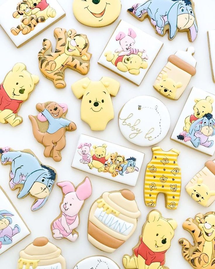 winnie the pooh and friends cookies are arranged on a white surface with various pictures