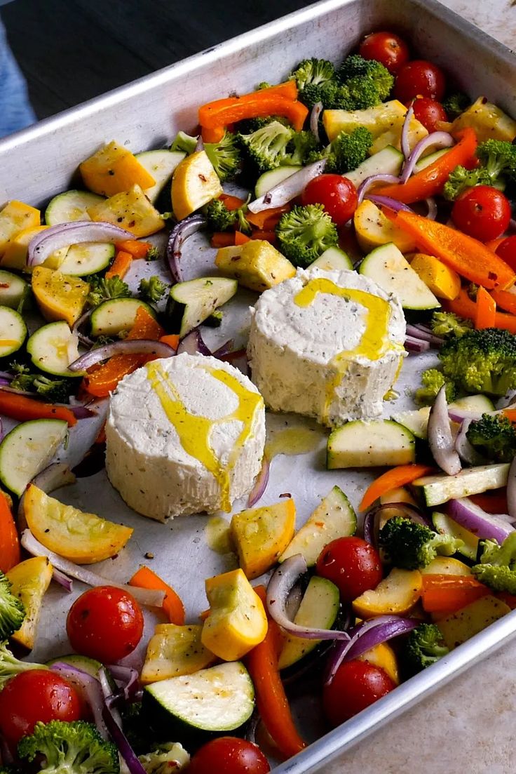 a metal pan filled with vegetables and cheese