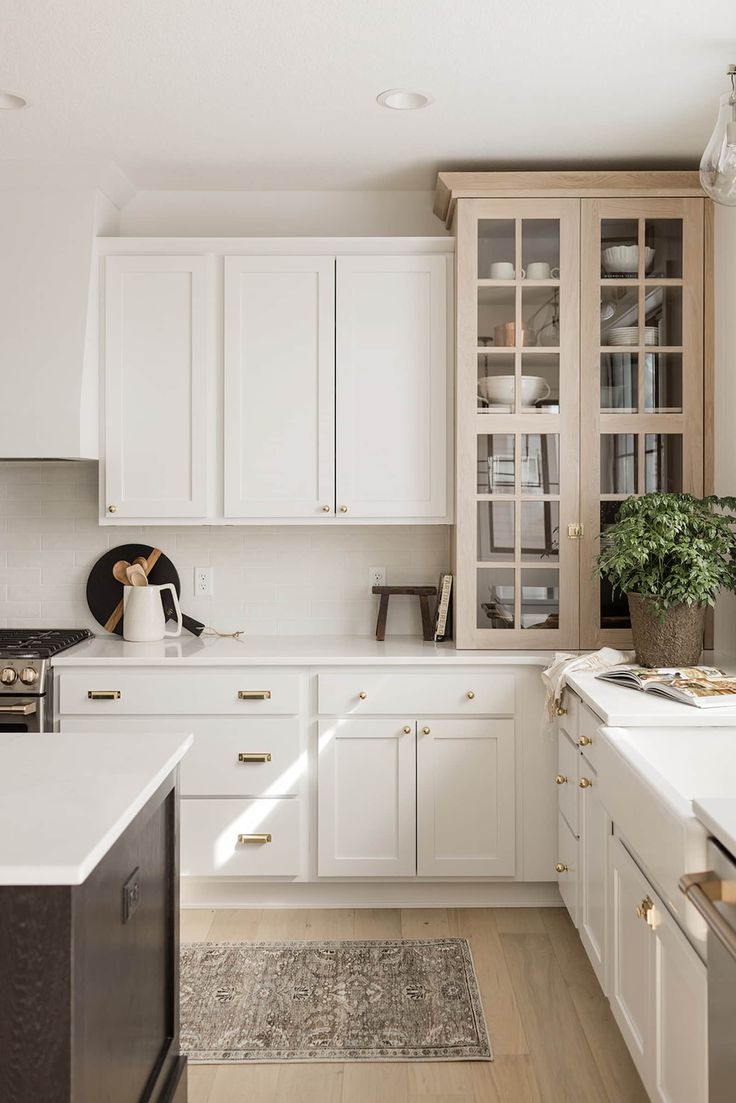 the kitchen is clean and ready for us to use it's white cabinetry