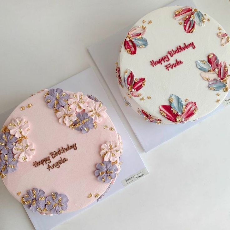 two decorated birthday cakes sitting next to each other on top of a white countertop