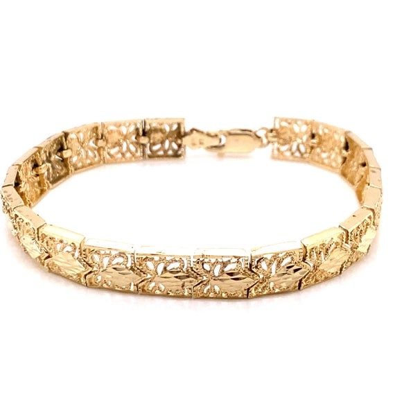 Vintage 14k yellow gold filigree link bracelet. The bracelet is 7" long and almost 8mm wide and features a lobster clasp. The bracelet weighs 14.03 grams of gold. Classic 14k Gold Bracelets With Intricate Design, Ornate Yellow Gold Bracelets For Formal Occasions, Ornate Yellow Gold Bracelet For Formal Occasions, Intricate Design Gold Bracelet For Formal Occasions, Classic 14k Gold Bracelet With Intricate Design, Yellow Gold Filigree Bracelet For Formal Occasions, Ornate Yellow Gold Jubilee Bracelet, Classic Gold Bracelet With Intricate Design, Classic Yellow Gold Filigree Bracelet