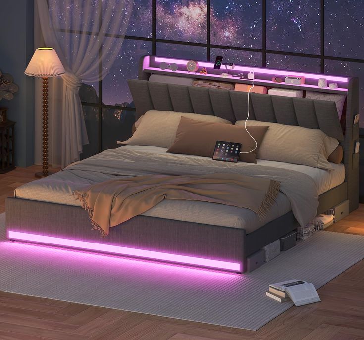 a bed that has some lights on it in front of a window with the night sky outside