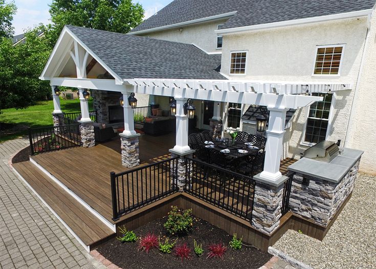 an outdoor patio with seating and pergolated area