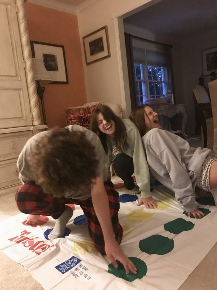 three people are doing crafts on the floor