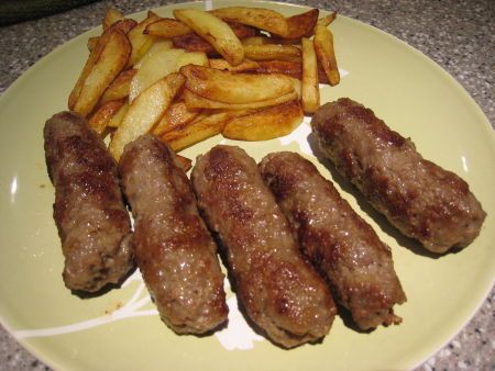 the plate is full of meat and french fries