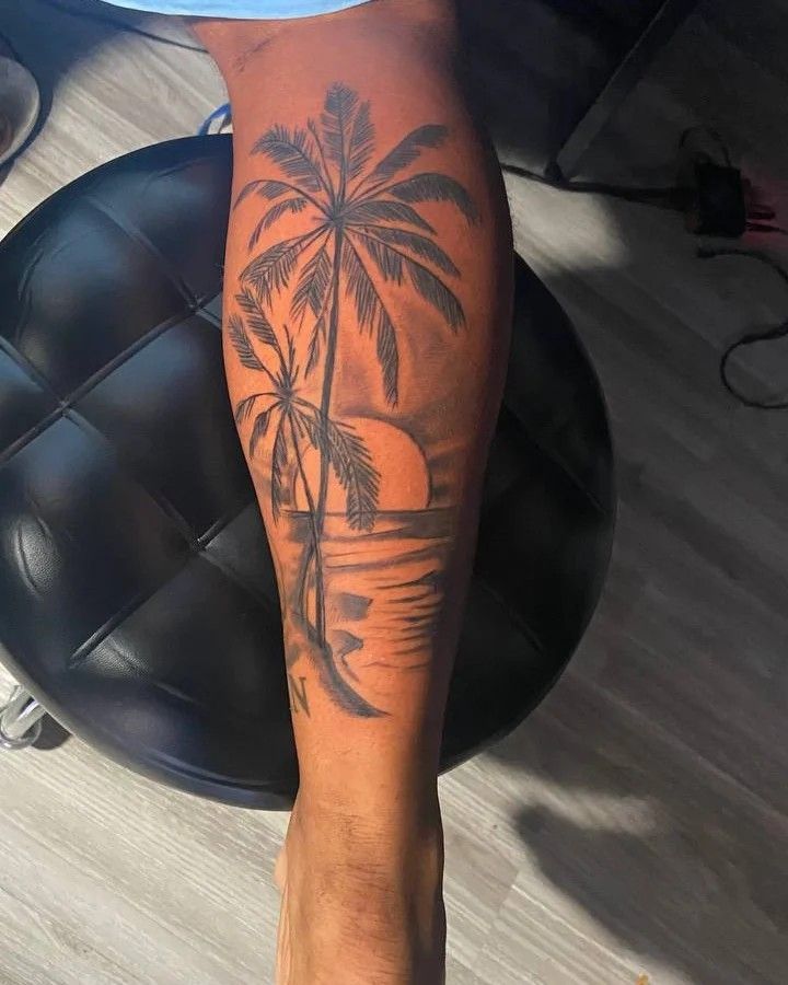 a man with a palm tree tattoo on his leg