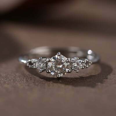 a three stone diamond ring sitting on top of a table