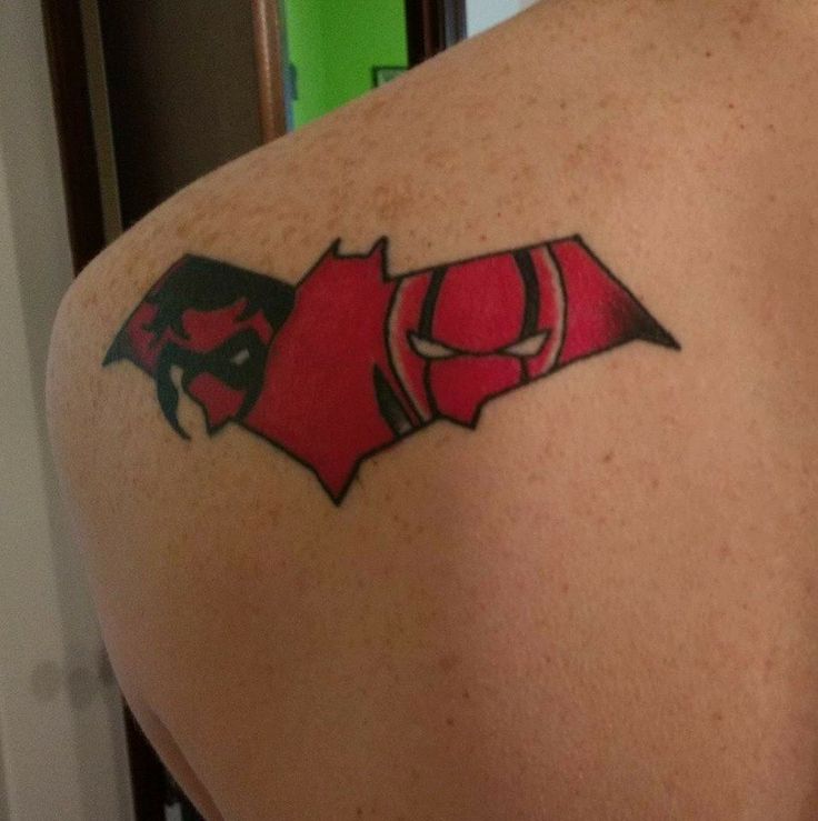 a man with a red bat tattoo on his back