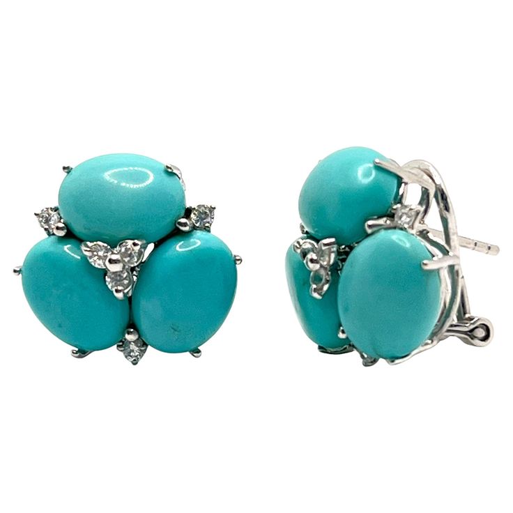 These stunning pair of earrings feature sets of oval cabochon-cut turquoise adorned with round simulated diamonds, handset in platinum rhodium plated sterling silver. The turquoise stones have natural blue-green hue - a striking color that looks so great on the ear. Straight post with omega clip back allowing the earrings to sit well on the ear. The earrings measured 11/16" height and across. Mark: "NUM 925" Gorgeous gemstone earrings! Great for everyday wear! A must have! Also available in yellow gold color or other gemstone combination - please contact us. Thank you for looking. Turquoise Stones, Turquoise Earrings, Oval Cabochon, Turquoise Stone, Gemstone Earrings, Rhodium Plated, Gold Color, Platinum, Blue Green