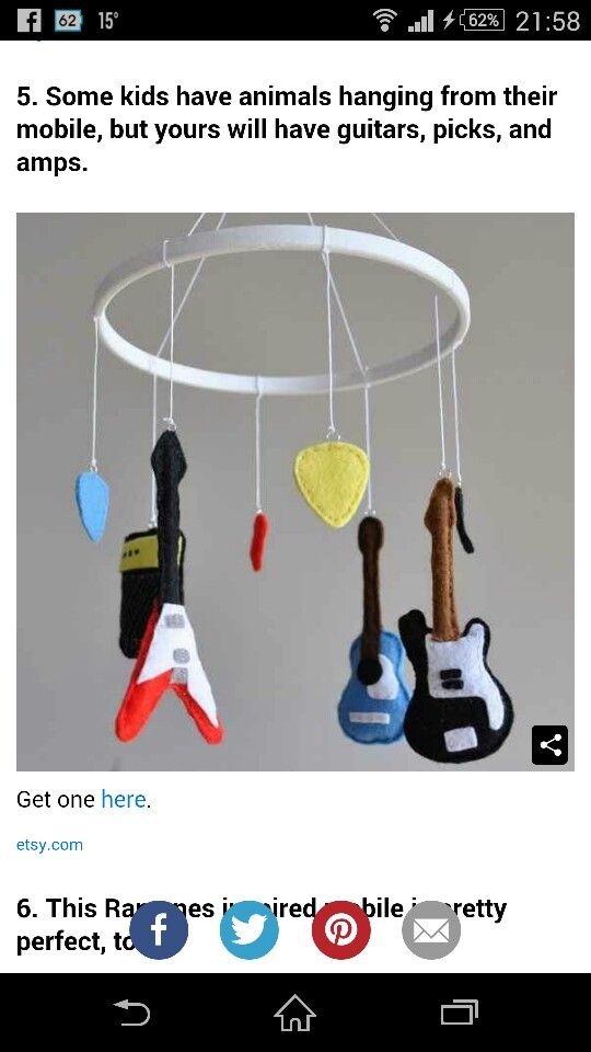 a mobile phone with an image of musical instruments hanging from it's hooks and strings