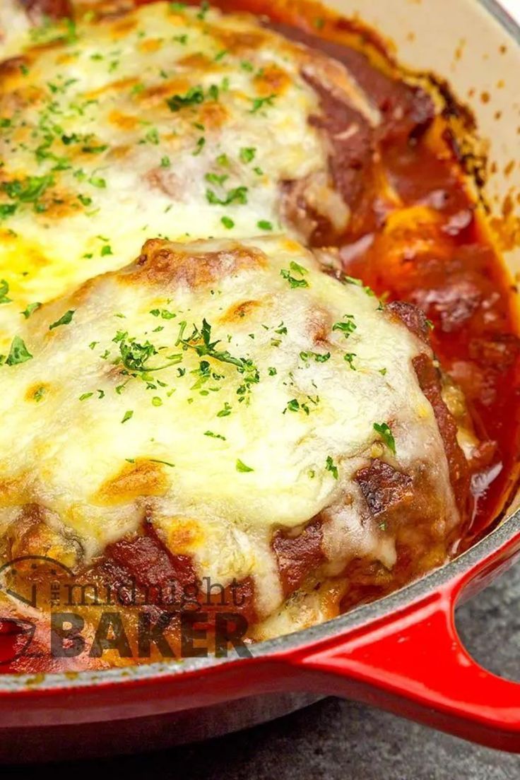 a casserole dish with meat and cheese in a red pan