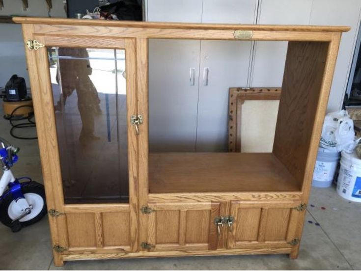 a large wooden cabinet with glass doors