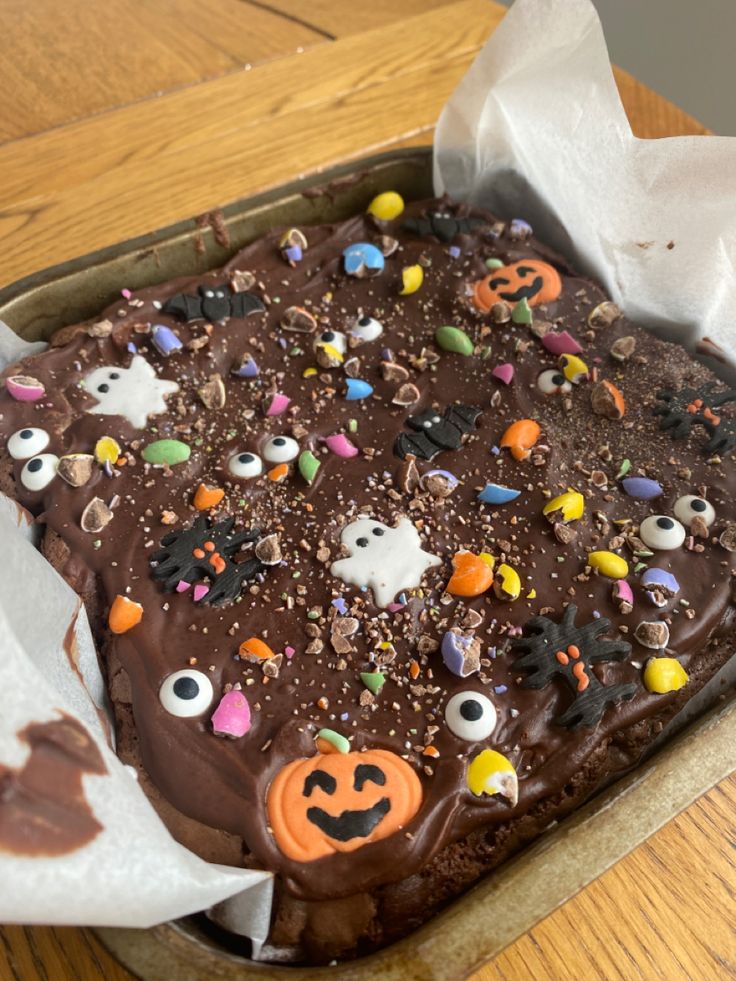 a cake in a box with chocolate frosting and sprinkles on it