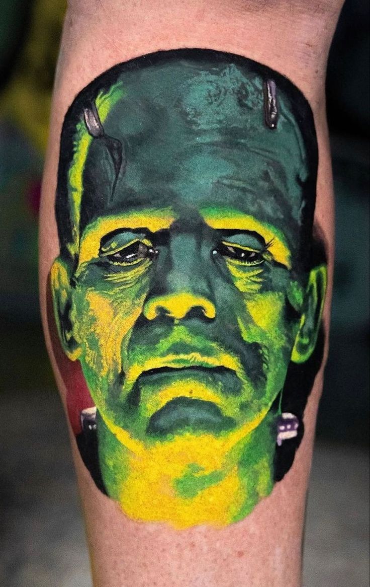 a man's leg with a green and yellow portrait on it