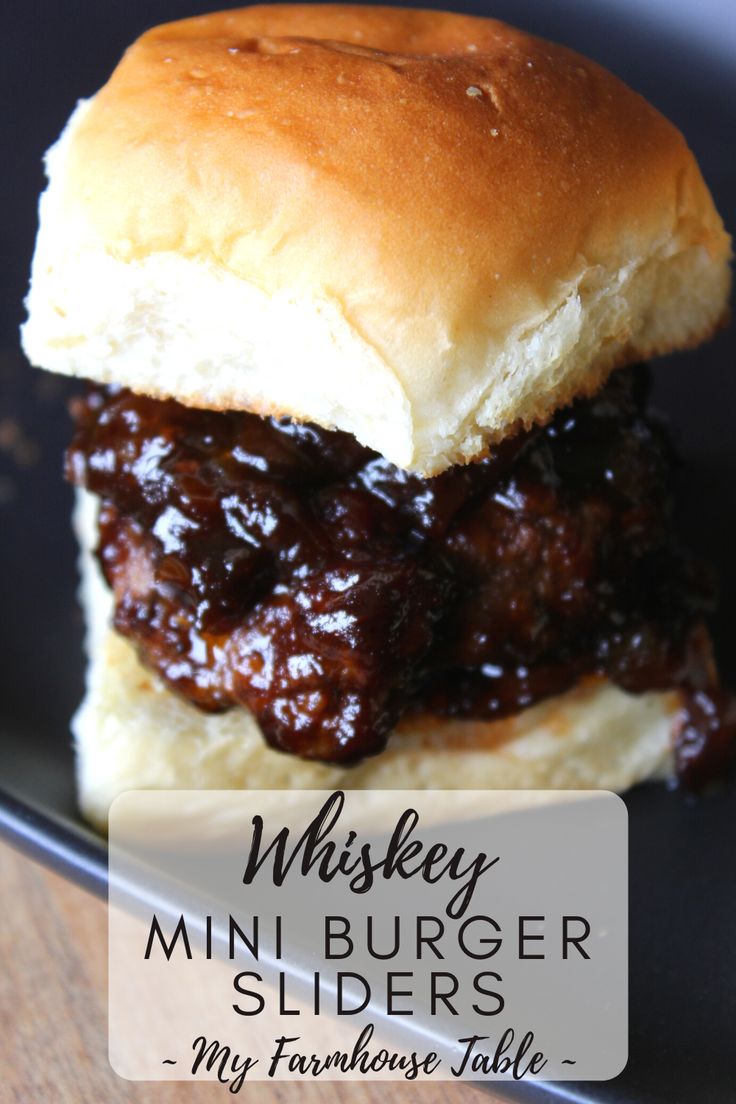 a close up of a sandwich on a plate with the words whiskey mini burger sliders