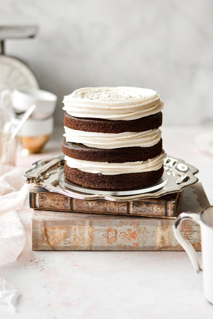 a cake sitting on top of a stack of books