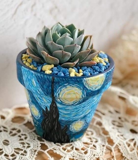 a succulent plant in a blue pot with the starry night painting on it