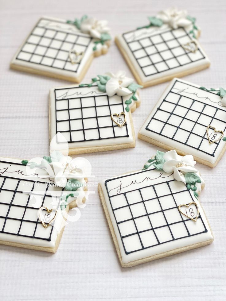 four decorated cookies are arranged in the shape of calendars with bows and ribbons on them