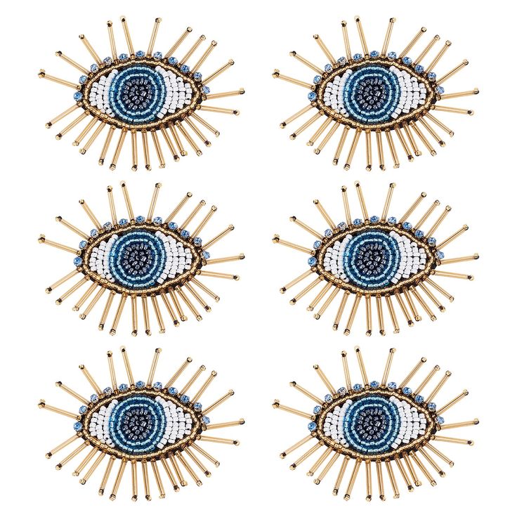 four pins with blue and white designs on them, all in the shape of an eye