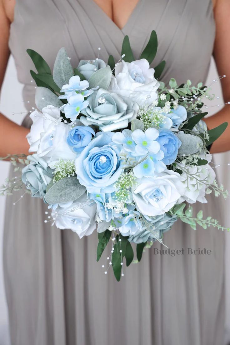 a bridesmaid holding a bouquet of blue and white flowers