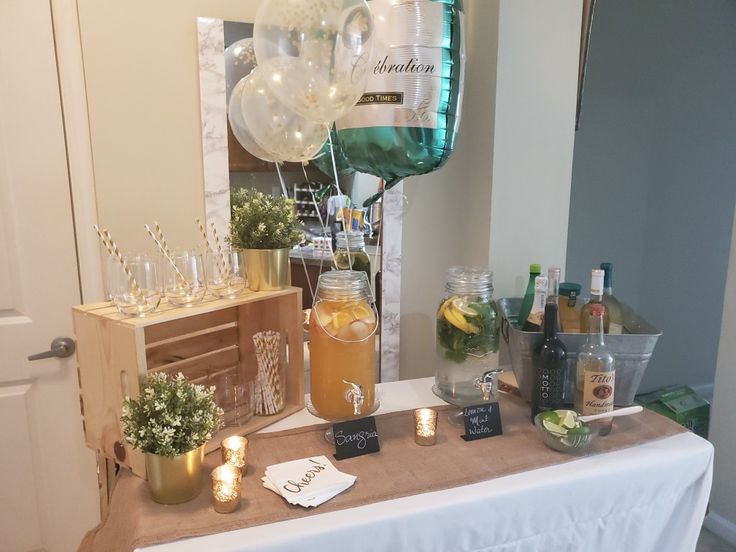 a table with drinks and balloons on it