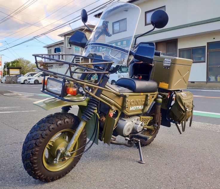 a motorcycle parked in front of a building on the side of the road with no one around it