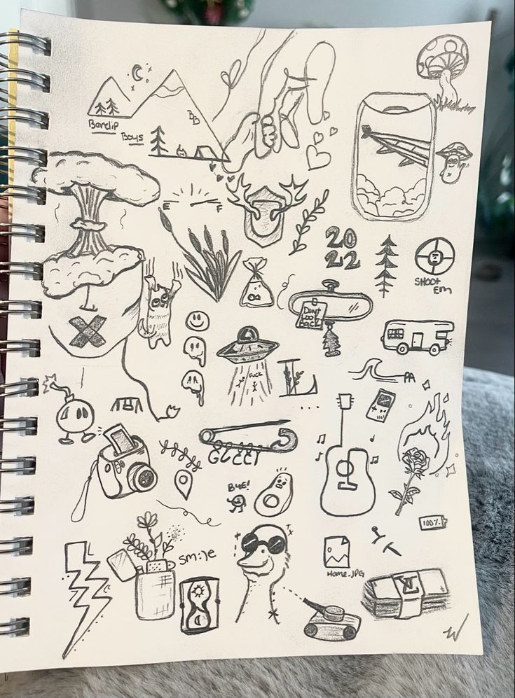 a notebook with drawings on it sitting on top of a table