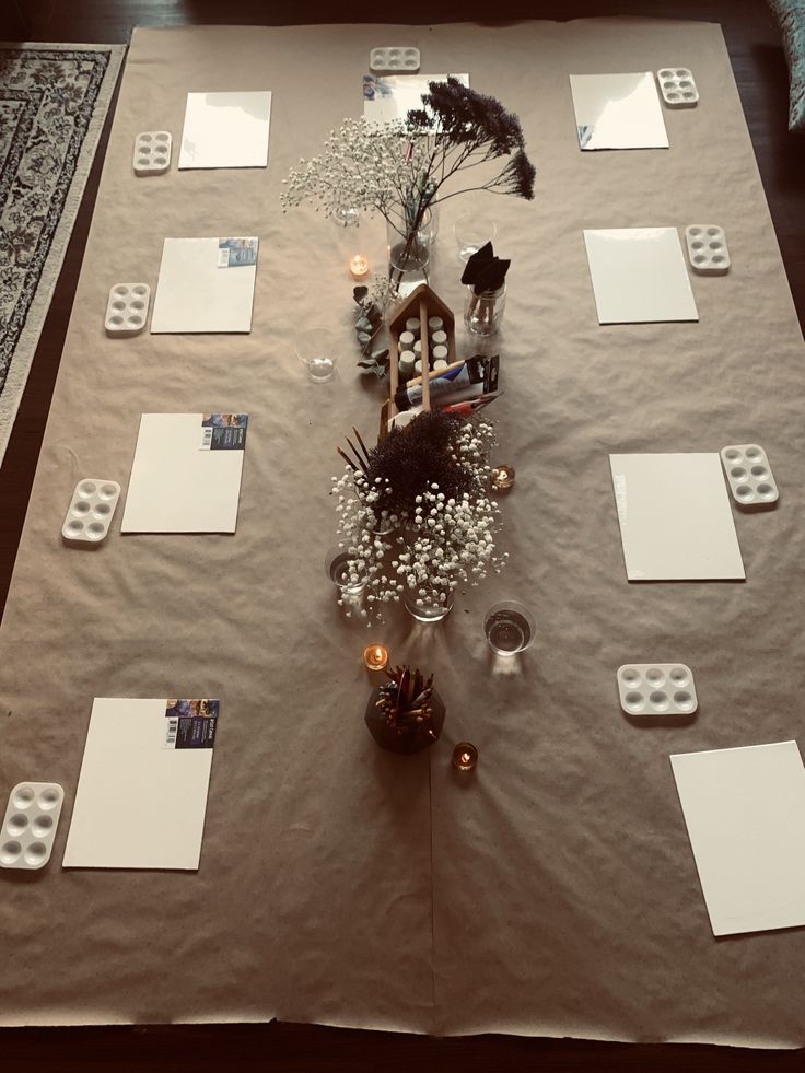 a table is set up with place mats and candles