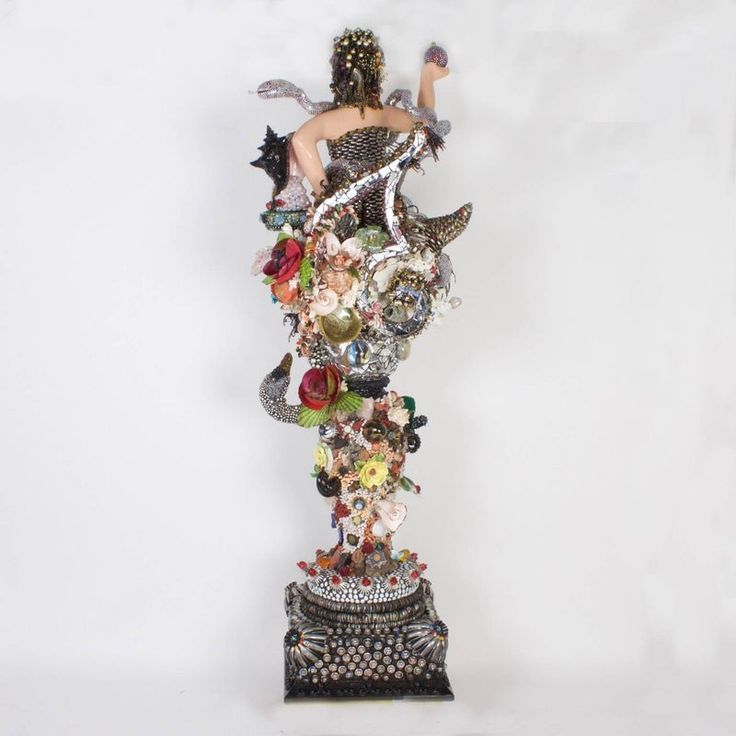 a statue made out of various objects on a white background