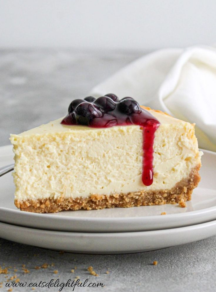 a slice of cheesecake with blueberries on top