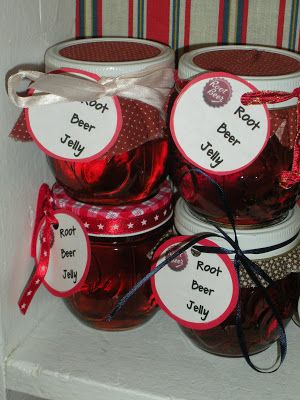 jars filled with red jelly sitting on top of a shelf