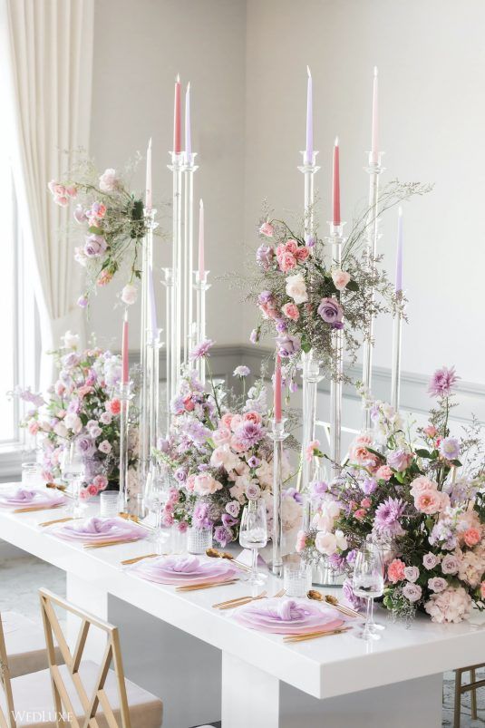 a long table with flowers and candles on it