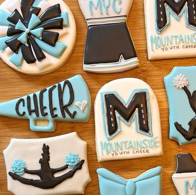 decorated cookies are arranged in the shape of cheerleaders and cheer mom's