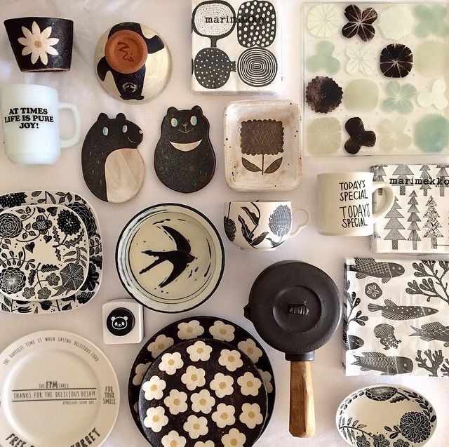 there are many different plates and dishes on the table with each one's own design