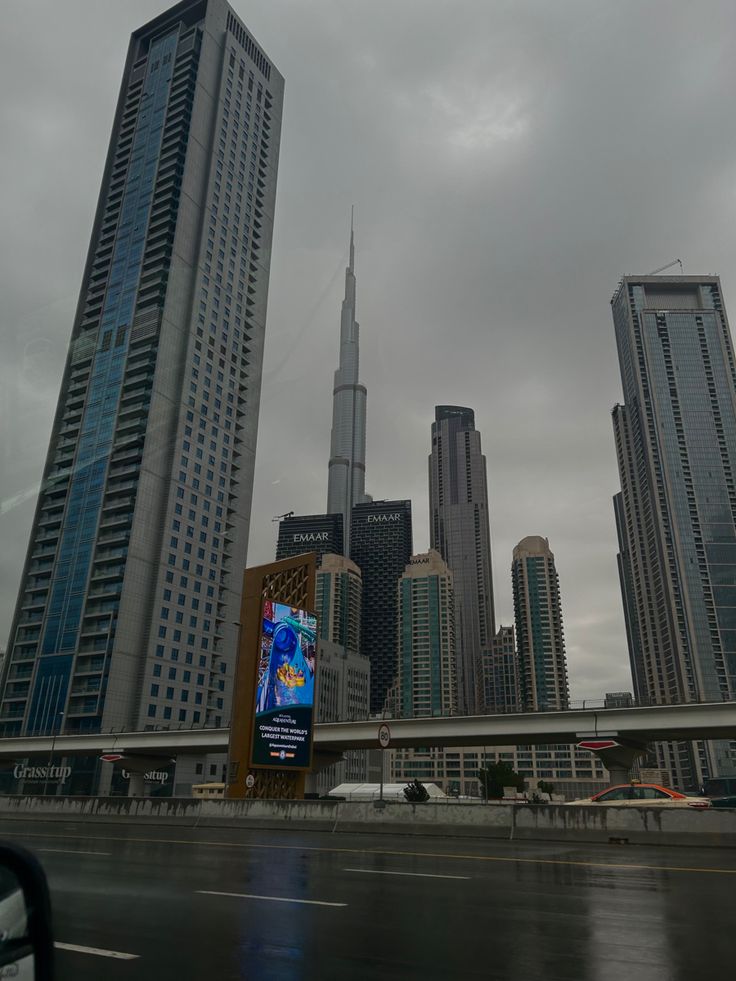 an image of a city with tall buildings in the background on a rainy day,