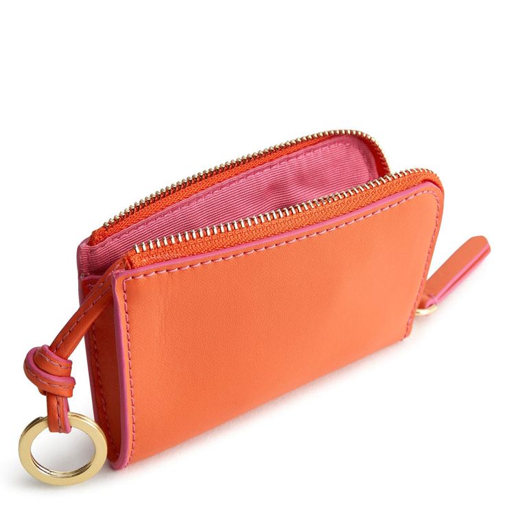 Streamline your wallet with our sleek Zip Card Pouch. Designed for those who prefer a minimalist approach to carrying cards and cash, this compact accessory offers convenient storage and easy access to your essentials while on the go. Whether you're running errands, grabbing coffee with friends, or heading out for a night on the town, our compact accessory keeps your essentials close at hand and your pockets free from clutter. Vera Bradley Zip Card Pouch in Orange Trendy Wallet With Rfid Blocking For Everyday Use, Trendy Wallets With Rfid Blocking For Everyday Use, Trendy Rfid Blocking Wallet For Everyday Use, Modern Coin Purse With Cell Phone Pocket, Trendy Rfid Blocking Coin Purse For Daily Use, Versatile Rectangular Wallet With Coin Pocket, Trendy Wallet With Card Slots For Everyday Use, Trendy Card Holder With Interior Slots, Trendy Wallets With Interior Card Slots