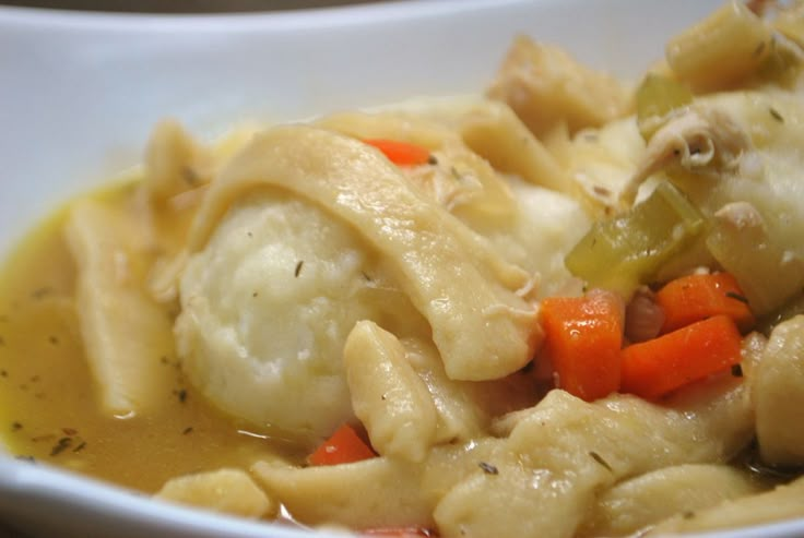 a white bowl filled with pasta and vegetables