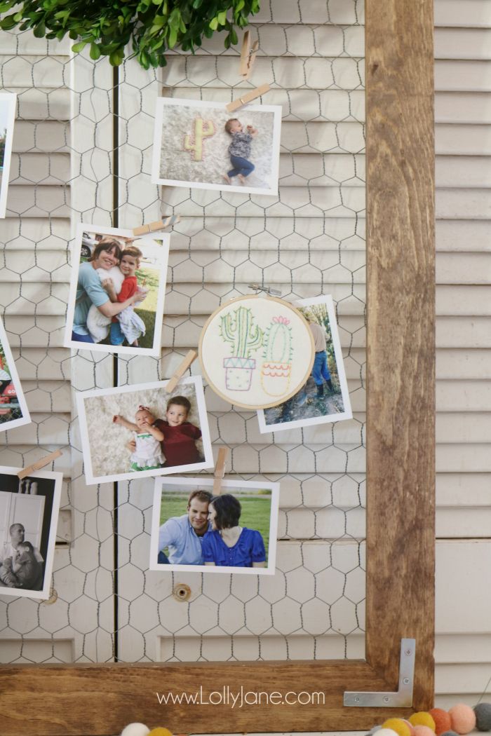 a bunch of pictures hanging on the side of a wall next to fruit and vegetables