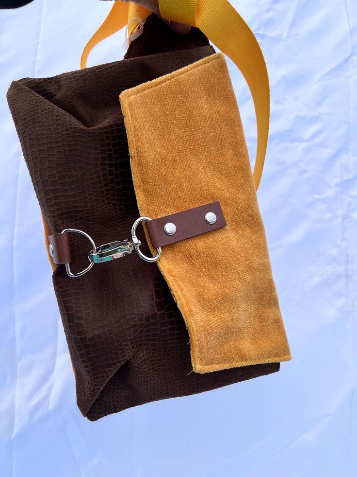 These hip bags have an adjustable soft strap allowing you to either wear it around your waist, or across your chest. These have a slim design so that they enter a room at the same time you do and not 2 steps ahead, and measure approximately 9.5"w by 2" d and 7" tall.   Closures are high quality hardware with a claw clasp and D ring design.  I have 3 variations: 1. Yellow velvet with silver hardware 2. Yellow velvet with gunmetal hardware 3. Faux cowhide with gunmetal hardware All bags have soft Brown Crossbody Belt Bag With Cell Phone Pocket, Belted Pouch Shoulder Bag, Brown Crossbody Belt Bag For On-the-go, Brown Belt Bag With Adjustable Strap For Daily Use, Brown Adjustable Strap Belt Bag For Daily Use, Travel Pouch Bag With Belt Detail, Travel Pouch Shoulder Bag With Belt, Travel Pouch Bag With Belt, Versatile Brown Shoulder Bag With Removable Belt