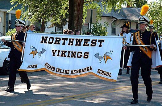 some people are marching down the street holding a banner that says north west vikings