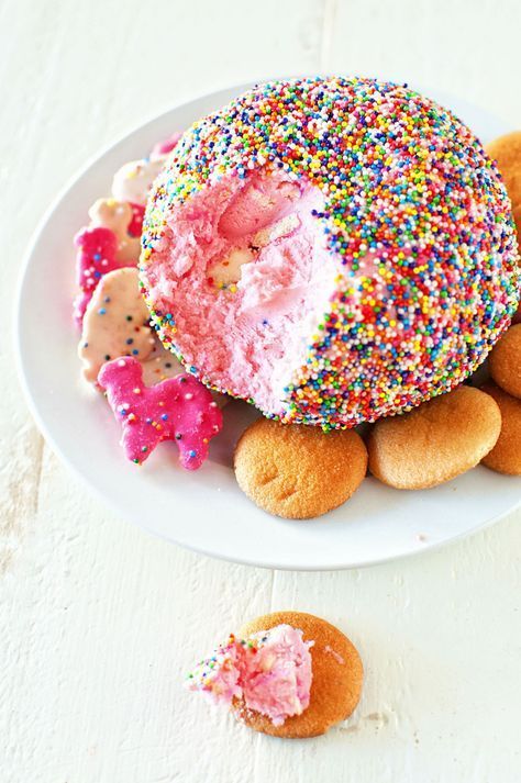 a white plate topped with donuts covered in sprinkles and frosting