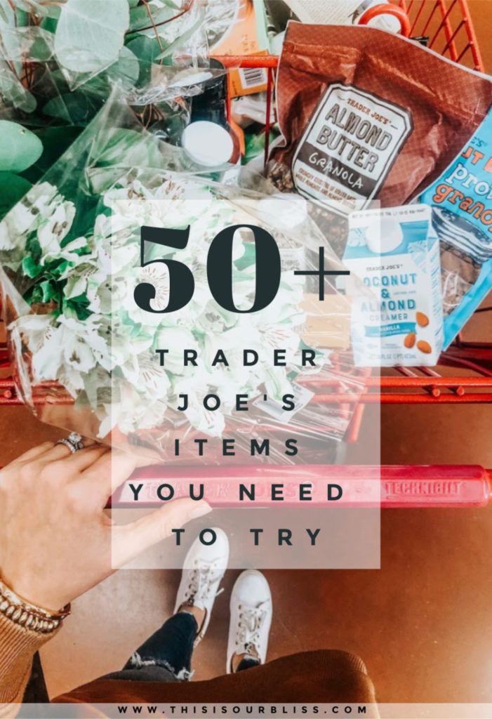 a woman's hand holding a shopping cart full of items with the words 50 + trader joes items you need to try