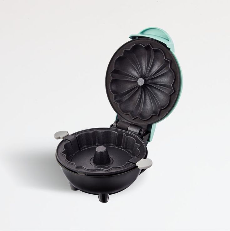 a black toilet with the lid up and wheels on it's side, in front of a white background